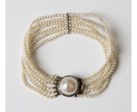 A six row bracelet of seed pearls on a cultured pearl and marcasite clasp, length 16.5cm, with an associated case.Buyer’s Pre