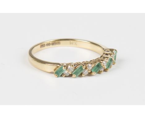 An 18ct gold, emerald and diamond half-hoop ring, mounted with a row of five rectangular cut emeralds in a slanting design, a