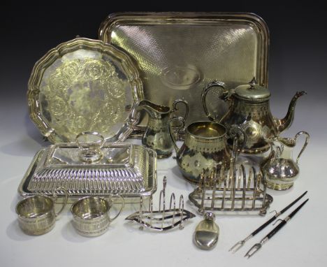 A group of plated items, including a tureen, cover and handle, salvers, a three-piece tea set and toast racks.Buyer’s Premium