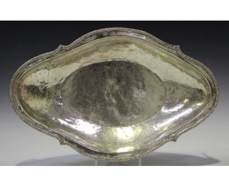 A Peruvian white metal bowl of shaped oval form with applied foliate rim and drop handles, unmarked, weight 1366g, length 43.