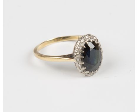 A gold, sapphire and diamond oval cluster ring, claw set with the oval cut sapphire within a surround of circular cut diamond