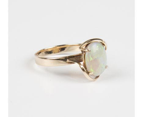 A gold ring, claw set with an oval opal in a twist abstract design, detailed '9ct', weight 2.1g, ring size approx N1/2, with 