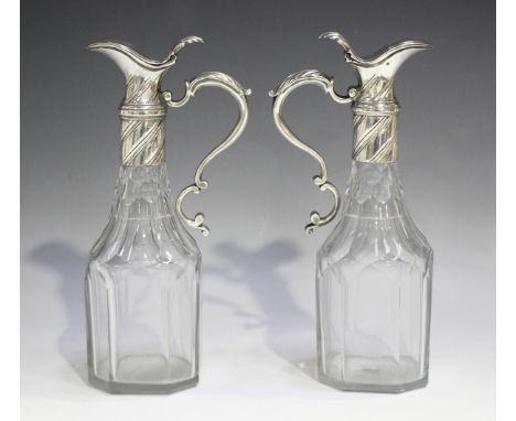 A pair of mid-18th century silver mounted cut glass oil and vinegar bottles, each facet cut body with a silver reeded spiral 