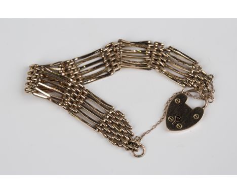 A gold bar and oval link gate bracelet on a gold heart shaped padlock clasp, detailed '9ct', weight 13.3g, length 17cm.Buyer’