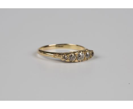 A gold and diamond five stone ring, circa 1900, mounted with a row of cushion cut diamonds graduating in size to the centre s