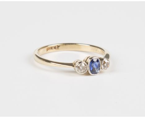 An 18ct gold, sapphire and diamond ring, collet set with an oval cut sapphire between circular cut diamond single stone sides