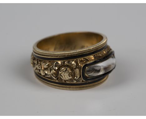 An early 19th century gold and black enamel mourning ring, glazed with a woven hair locket compartment with floral decoration