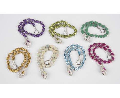 A group of seven silver and variously coloured gemstone set bracelets, each designed as a serpent, including amethyst, perido