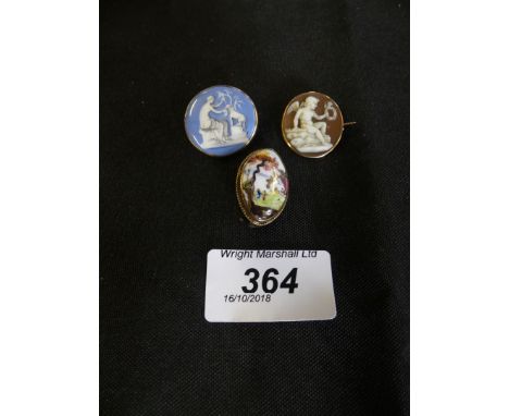 Three brooches to include a shell cameo brooch and two enamel brooches (3) 