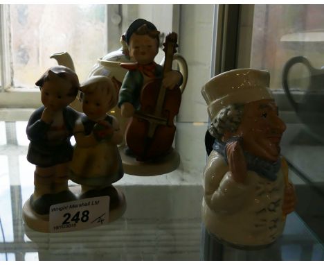 A mixed lot comprising two Goebel figures of children, a Royal Doulton character jug from The Doulton Ville Collection and a 