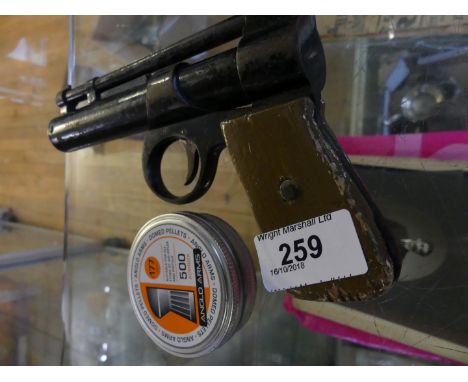 A vintage air pistol and pellets 
