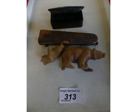 A mixed lot comprising two small carved Black Forest bears, a small papier-mache snuff box, and a cased pipe stem 