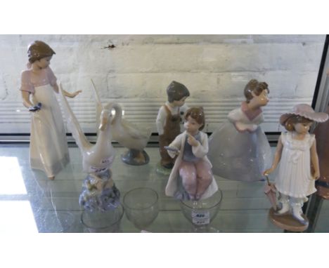 A collection of Nao ornaments comprising six various figures and two model swans (6) 