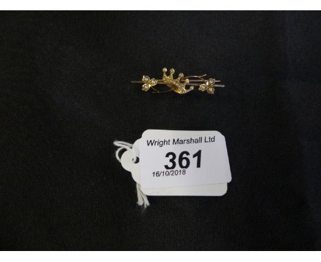 An early 20th century split pearl bar brooch, the split pearl crown with foliate asymmetric sides atop the polished bar, leng