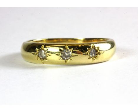 A gentleman's 18ct yellow gold three diamond set gypsy ring, (K.5).