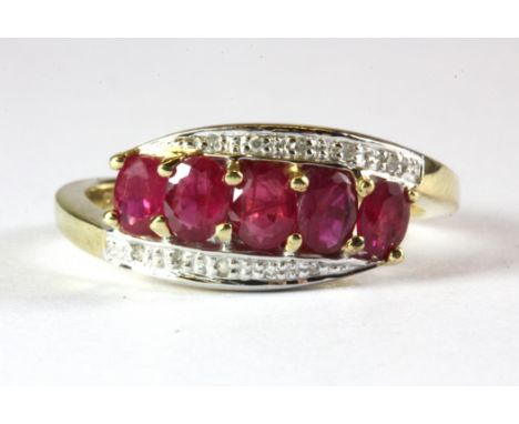 A 9ct yellow gold ruby and diamond set ring, (N.5).