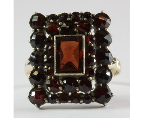 A 9ct yellow gold garnet set large cluster ring, (R.6).