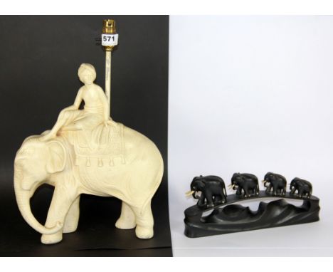 A 1930's plaster table lamp of a boy riding an elephant, H. 43cm, together with an elephant bridge.