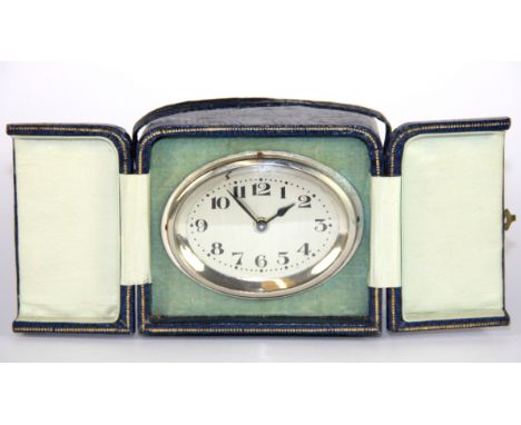 A leather cased 1930's travelling clock, 11 x 8 x 8cm.
