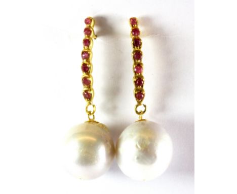 A pair of 925 silver gilt drop earrings set with rubies and large pearls, L. 4cm, pearl dia. approx. 1.5cm.