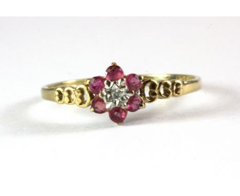 A 9ct yellow gold ruby and diamond cluster ring, (O.5).