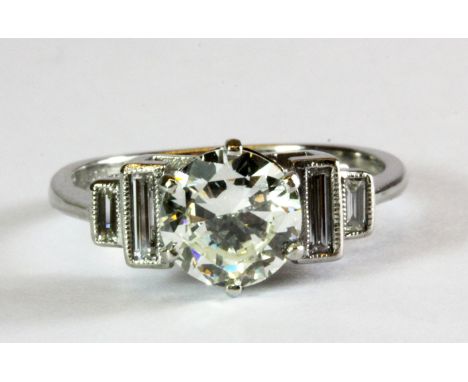 A platinum solitaire ring set with a 1.07ct diamond, clarity VS1, colour I, and baguette diamond set shoulders, understood to