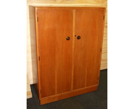 A light oak veneered tallboy, 83 x 46 x 122cm.