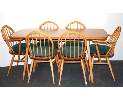 An Ercol dining table and six chairs.