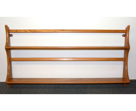 An Ercol wall mounted plate rack, W. 96cm.