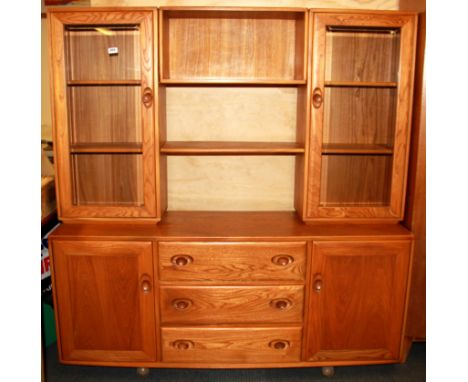 An Ercol modular sideboard with cabinets above, W. 156cm, H. 163cm.