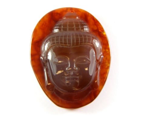 A lovely carved amber coloured agate amulet of a Buddha head, H. 5.5cm.