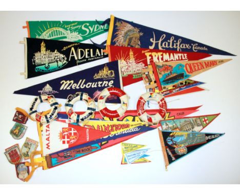 A collection of vintage travel pennants and life belts.