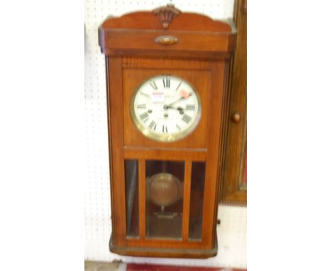 A 1930s walnut drop trunk wall clock, having a three train movement