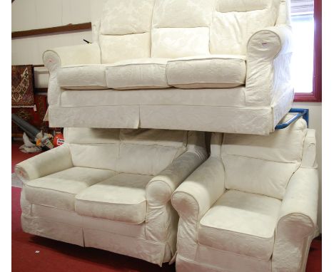 A modern floral white upholstered three piece suite comprising; triple sofa, double sofa, and single armchair