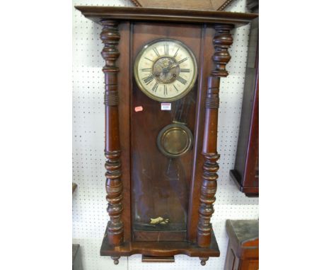 An early 20th century walnut cased Vienna style drop trunk wall clock