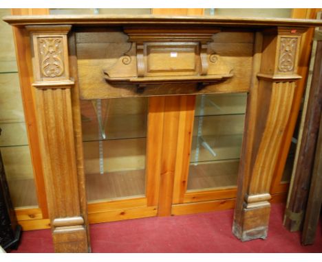 An Edwardian carved oak fire surround, height 139cm, width 152cm