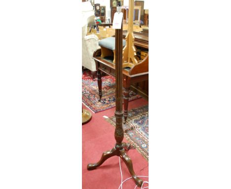 A mahogany reeded and low relief floral carved pedestal standard lamp
