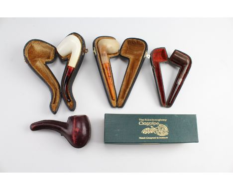 Three cased vintage Meerschaum pipes, together with a cased silver mounted walnut pipe, and an Irish clay pipe