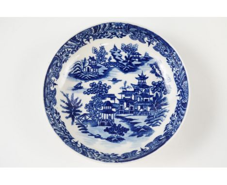 An 18th Century underglaze blue Worcester saucer in the Bandstand pattern, the base having underglaze blue crescent mark, 12 