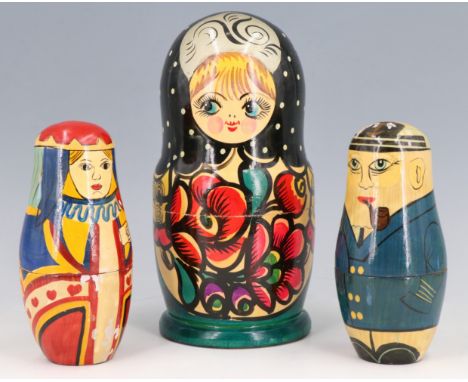 A vintage Russian Martyoshka doll together with two others decorated as naval officers and suit of hearts court playing cards