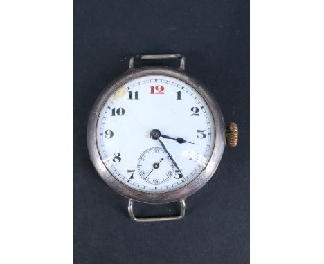 A Great War silver trench watch, having an un-named movement and enamel face with "red 12", subsidiary seconds dial and blued