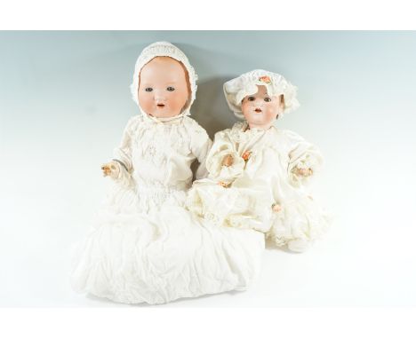 Two vintage Armand Marseille bisque headed dolls, 351/6.K and 990 respectively, one wearing a white metal christening bangle,