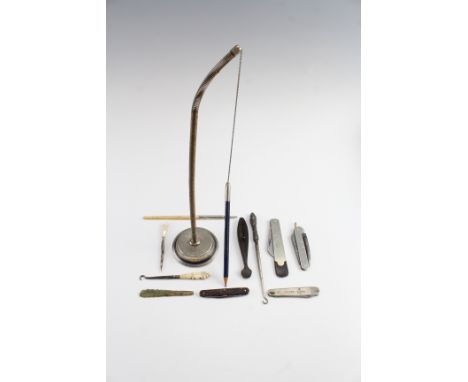 A group of collectibles, including pocket knives, button hooks, a fleam, a counter-top pen holder, a bone pencil, etc