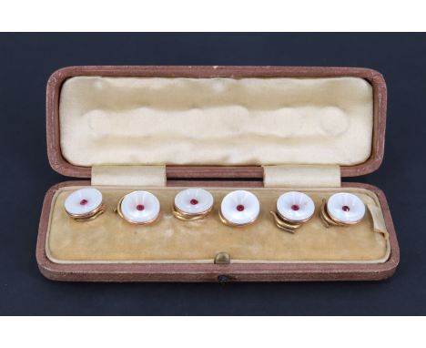 A cased set of six early 20th Century mother-of-pearl waistcoat buttons, each having a concave front centrally set with an ei