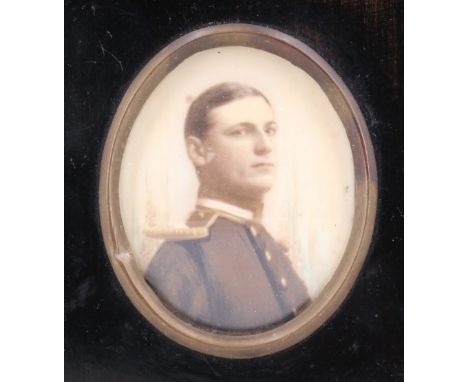 A hand tinted photographic portrait of a Naval Officer in full dress, late 19th / early 20th Century, in Georgian style black