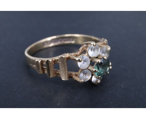 A 1970s green and white set 9 ct gold daisy ring, the central 4 mm green brilliant quartz set above six surrounding 3 mm bril