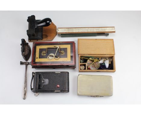 A vintage hole punch, petty cash tin, slide rule, bullion scales, Kodak folding camera, etc