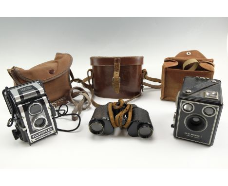 A Ross Ensign Ful Vue Flex camera together with a Kodak Six 20 "Brownie" C camera and Schutz 8 x 25 binocular field glasses