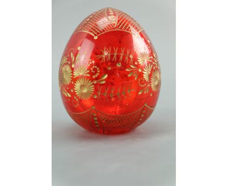 A late 20th Century Faberge ruby glass egg, having gilt wheel engraved decoration, 9 cm