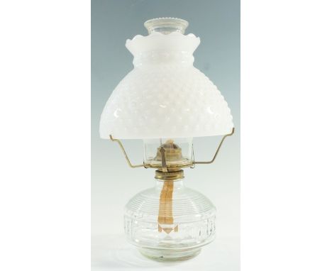 A vintage pressed glass and brass oil lamp, having a single four-prong burner and a white glass shade, 33 cm to shade